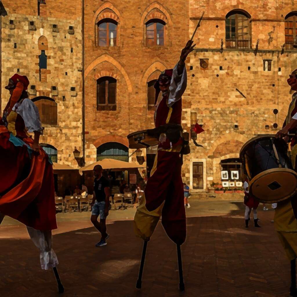 Stilt walkers in front of Torre Chigi and Palazzo del Podestà, San Gimignano, Italy